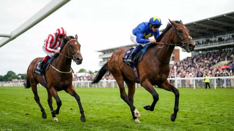 Jockey on horseback crossing the finish line in second place at a UK horse racing track